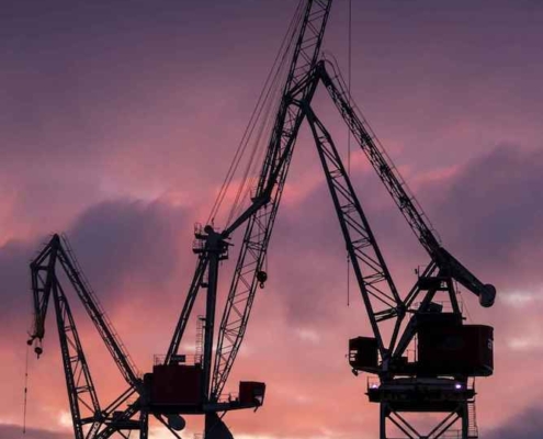 Shipyard environment highlighting teamwork, safety, and careful work in ship construction.