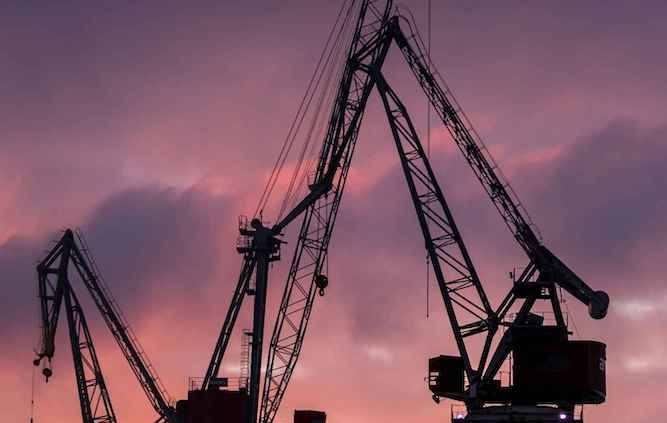 Shipyard environment highlighting teamwork, safety, and careful work in ship construction.